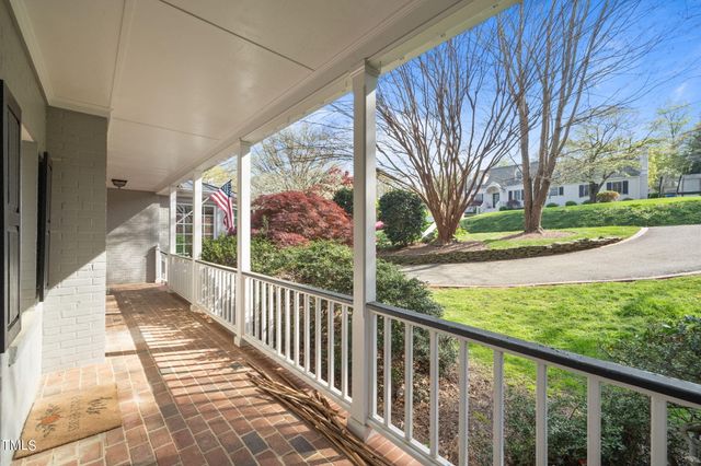 a view of a porch with wooden floor and fence