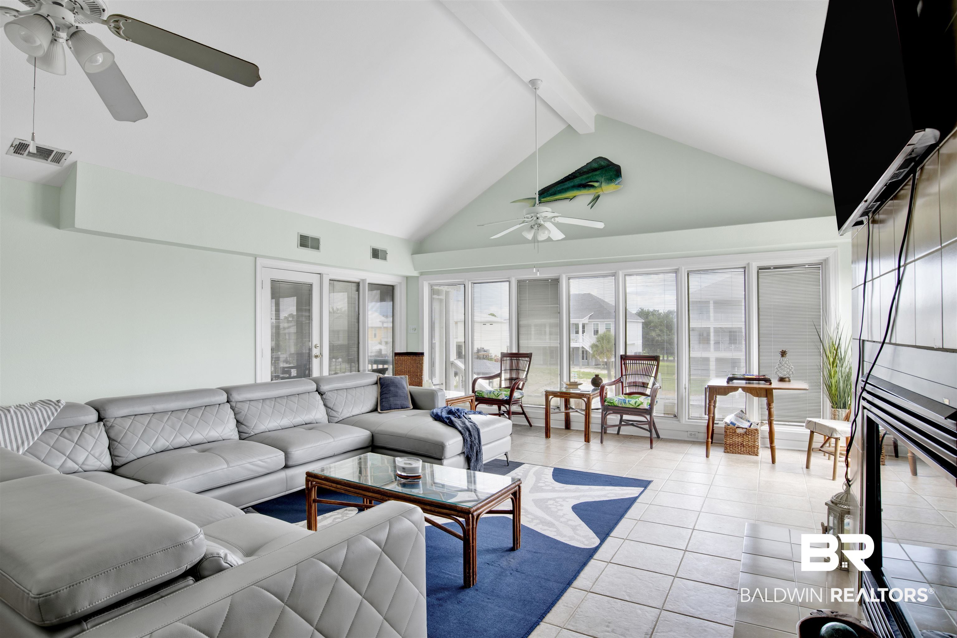 33093 River Road Orange Beach, AL 36561 - Photo 5 of 30 Tiled living room with beam ceiling, ceiling fan, and high vaulted ceiling