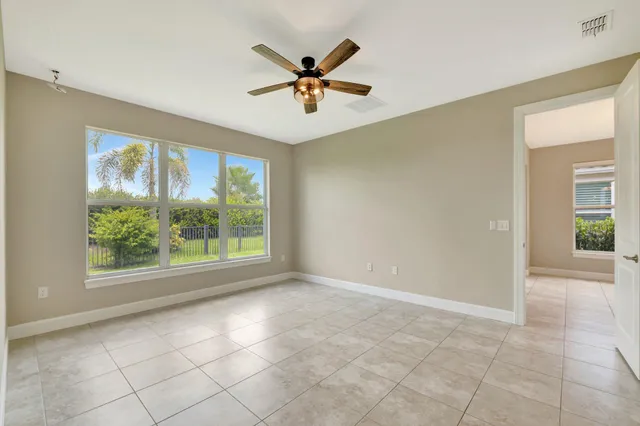 a spacious bathroom with a sink a toilet a mirror and shower