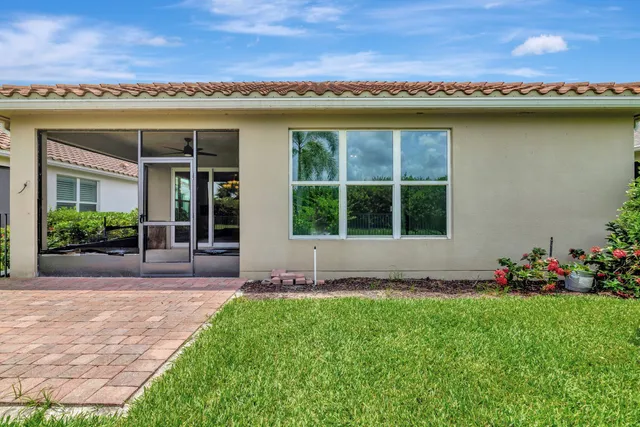 a view of a garden with plants and a bench