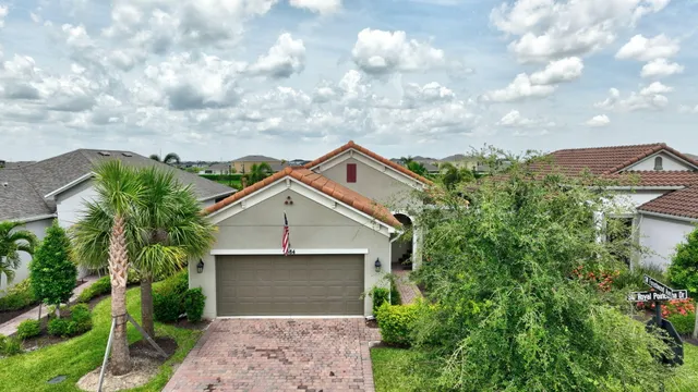 an aerial view of a house with garden space and lake view in back