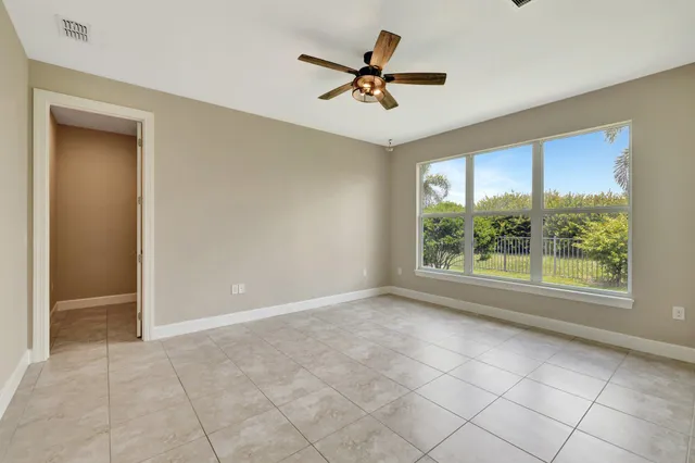 a view of a livingroom with a ceiling fan and window