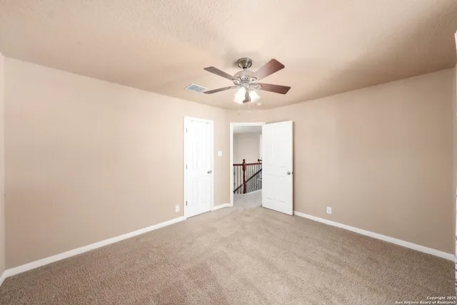 a view of a room with a ceiling fan