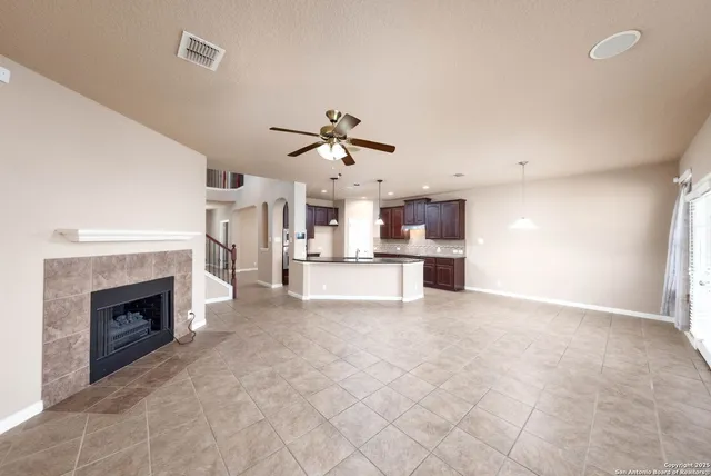 a kitchen with stainless steel appliances granite countertop a sink a stove and a wooden cabinets