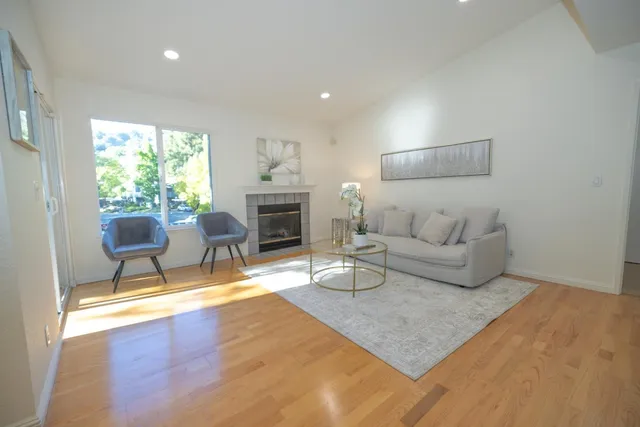 a living room with furniture and a fireplace