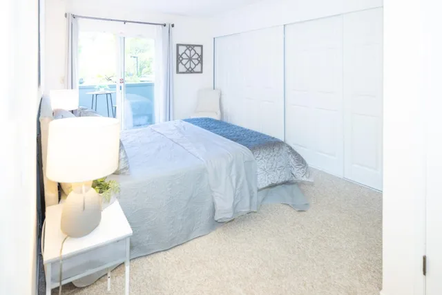 a bedroom with a bed and a mirror