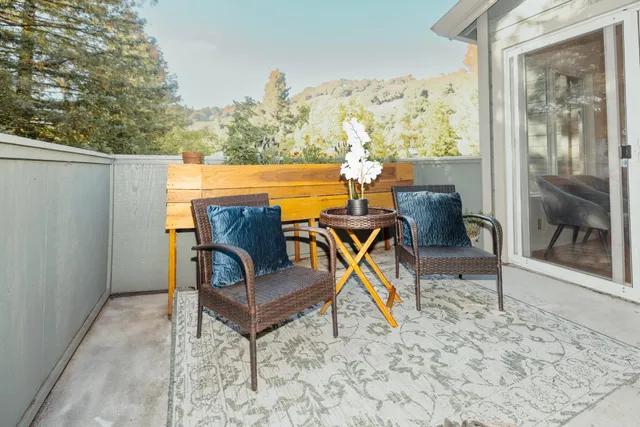 a view of a chairs and tables in the back yard of the house