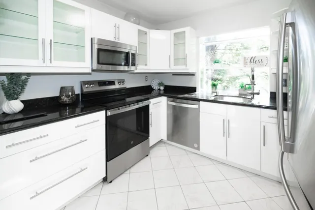 a kitchen with a stove a sink and a microwave