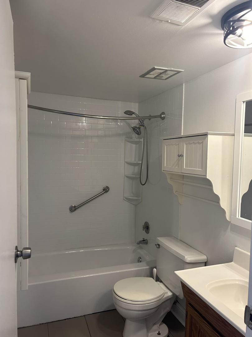 1713 Bristol Walk Hoffman Estates, IL 60169 - Photo 11 of 14 a bathroom with a granite countertop toilet sink and shower