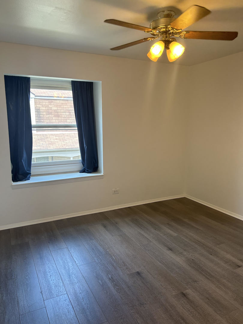 1713 Bristol Walk Hoffman Estates, IL 60169 - Photo 12 of 14 a view of empty room with wooden floor and fan
