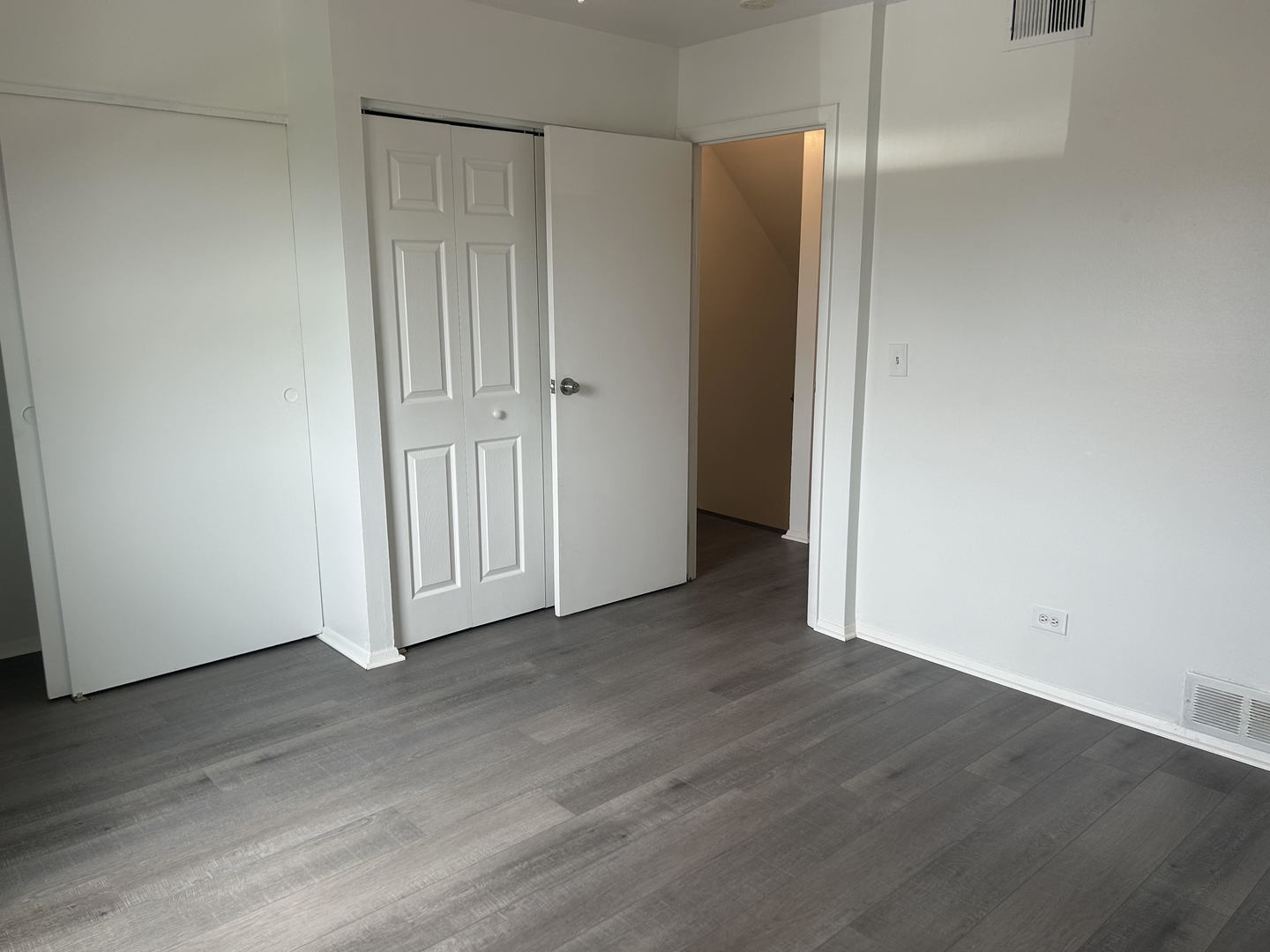 1713 Bristol Walk Hoffman Estates, IL 60169 - Photo 10 of 14 an empty room with wooden floor and closet area