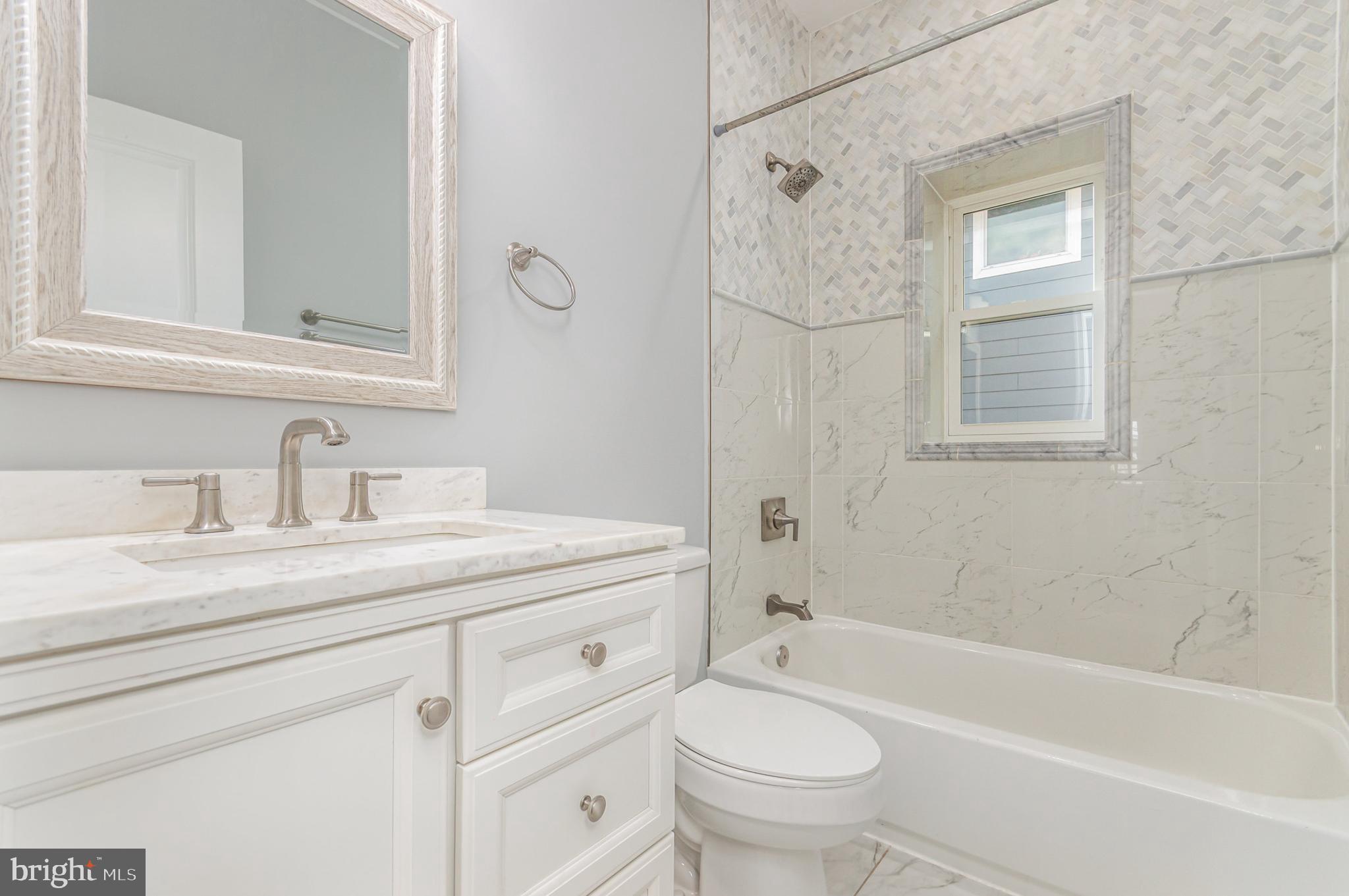 3110 Perry Street, Unit B Mount Rainier, MD 20712 - Photo 8 of 24 a bathroom with a granite countertop sink toilet and shower