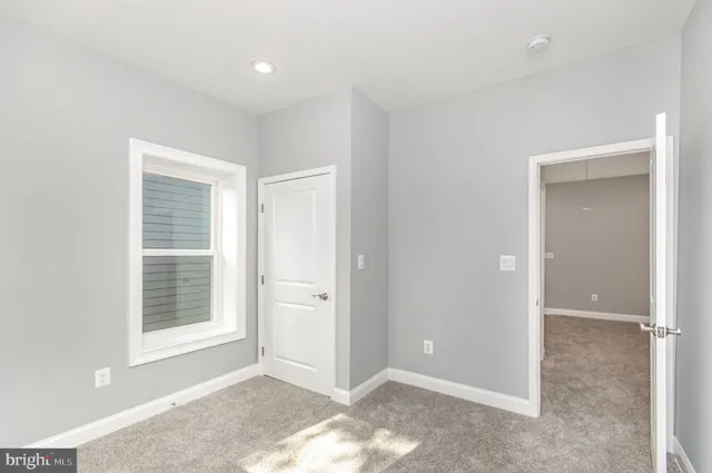 a view of room with window and hardwood floor