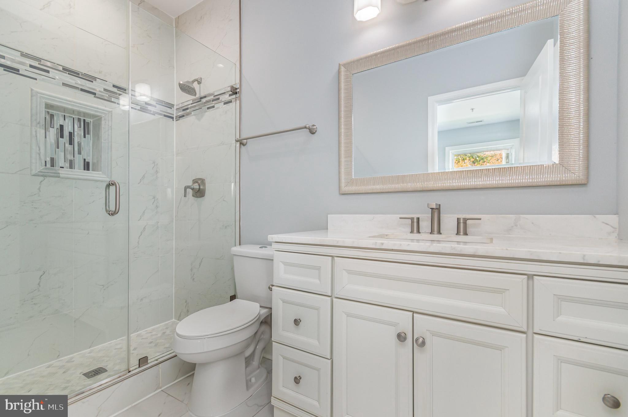 3110 Perry Street, Unit B Mount Rainier, MD 20712 - Photo 13 of 24 a bathroom with a sink a toilet and shower