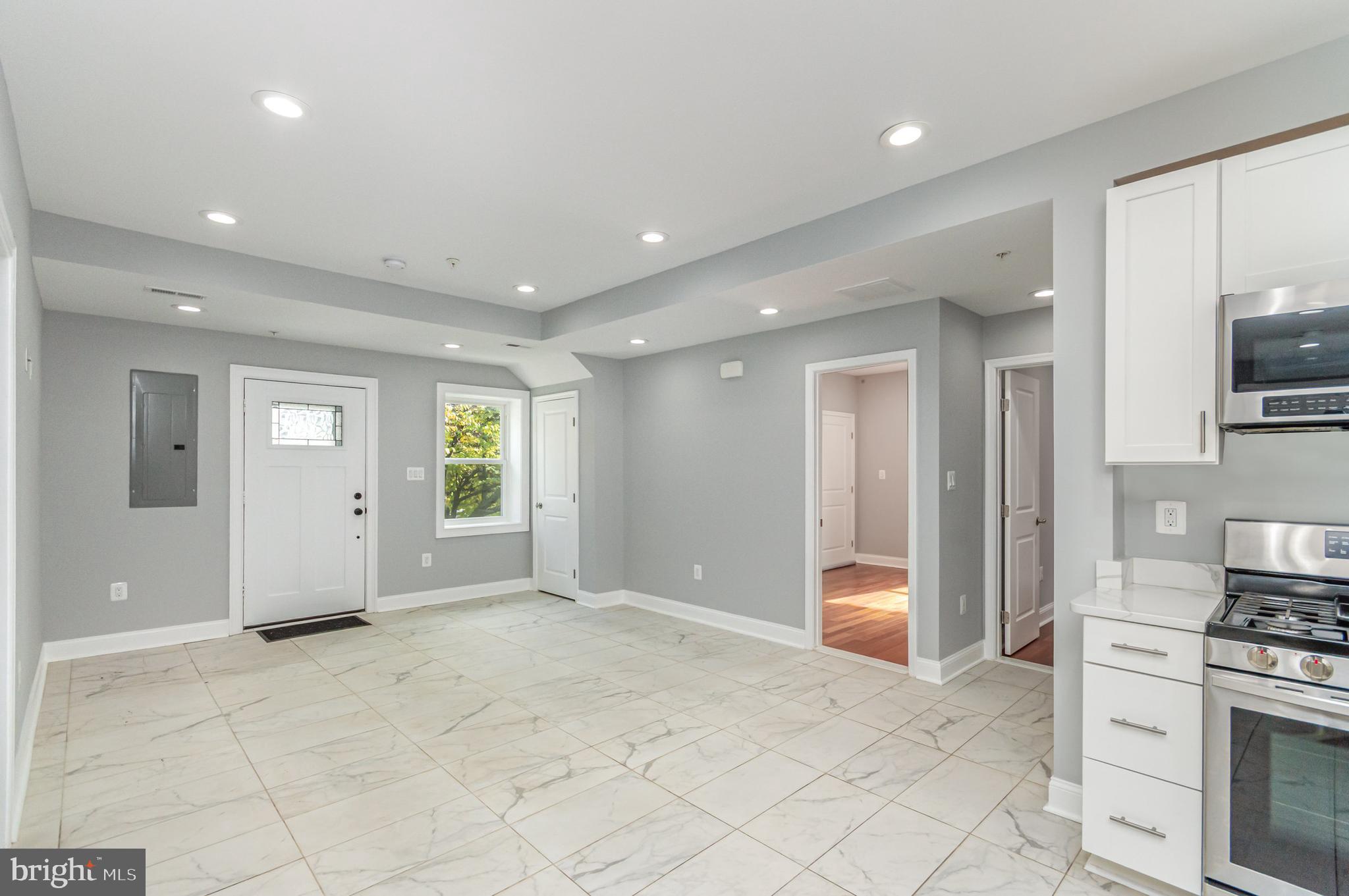 3110 Perry Street, Unit B Mount Rainier, MD 20712 - Photo 22 of 24 a view of a kitchen with an entryway and a stove