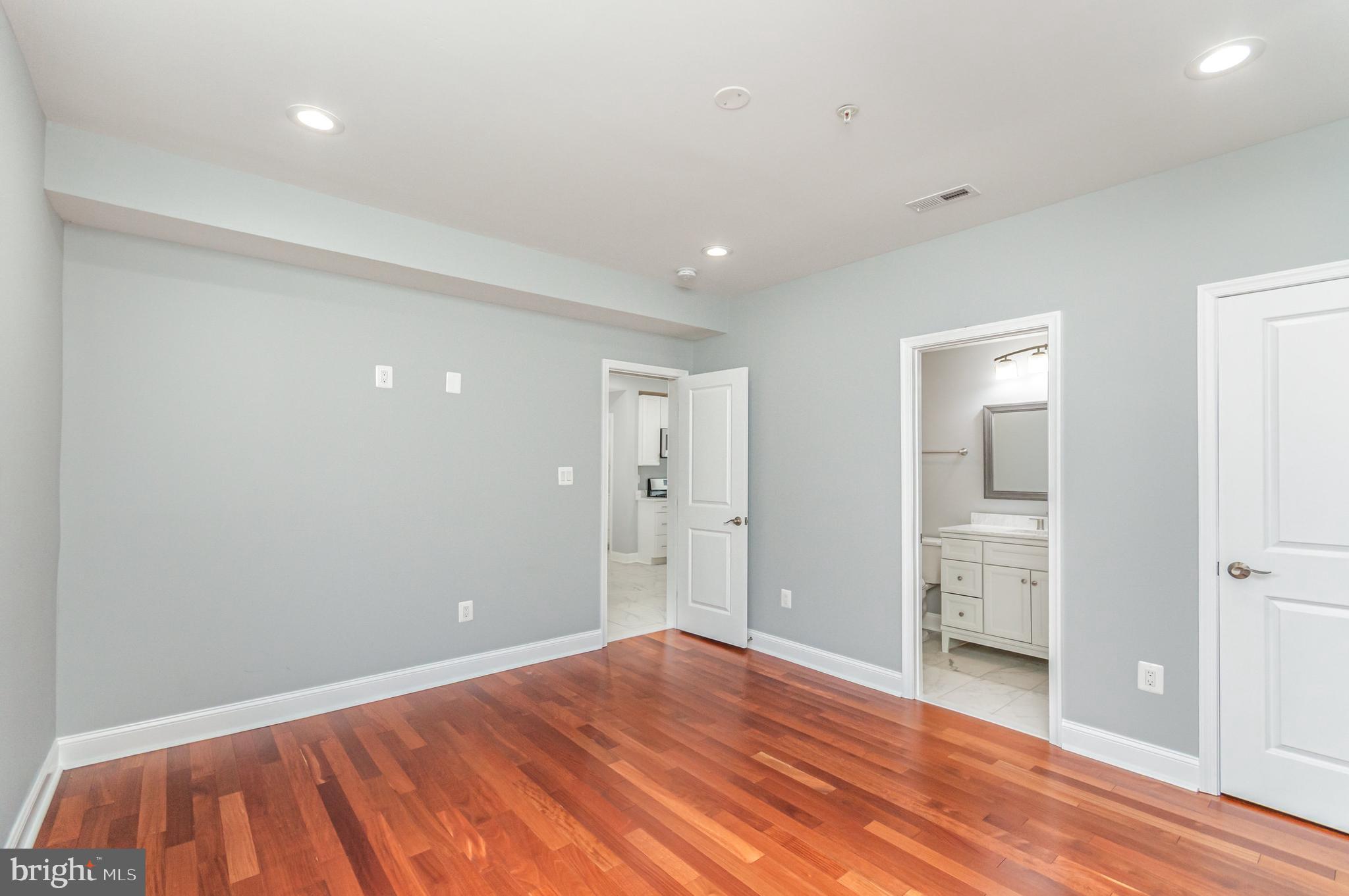 3110 Perry Street, Unit B Mount Rainier, MD 20712 - Photo 5 of 24 wooden floor in an empty room with a window
