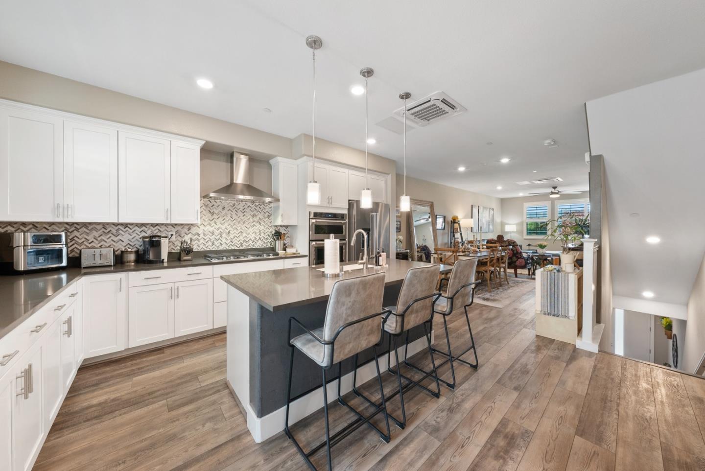 6725 Magnetic Loop San Jose, CA 95119 - Photo 20 of 68 a kitchen with lots of counter top space and painting on the wall