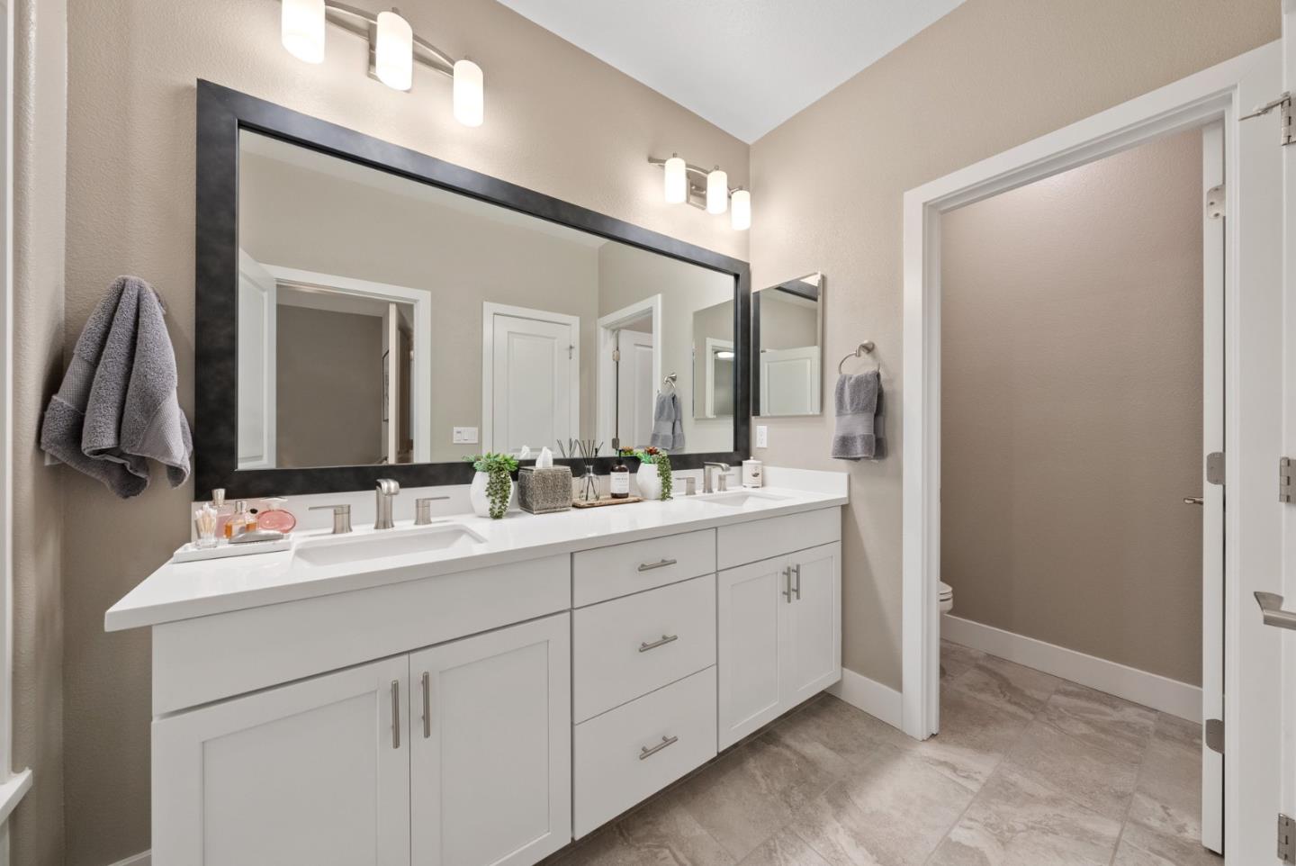 6725 Magnetic Loop San Jose, CA 95119 - Photo 38 of 68 a bathroom with a double vanity sink and a mirror