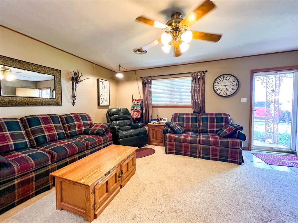 1009 North 7th Street Haskell, TX 79521 - Photo 5 of 26 a living room with furniture a window and a clock