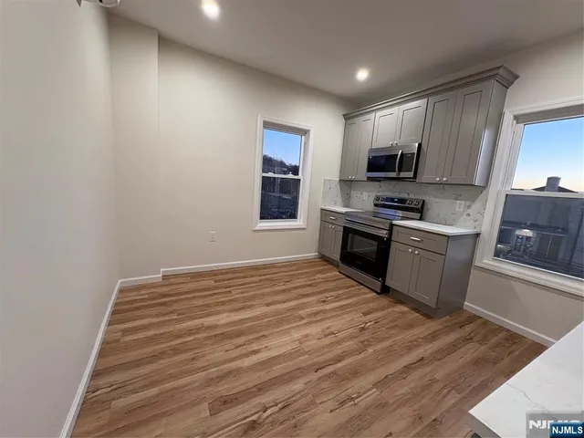 a kitchen with a stove a sink and a microwave