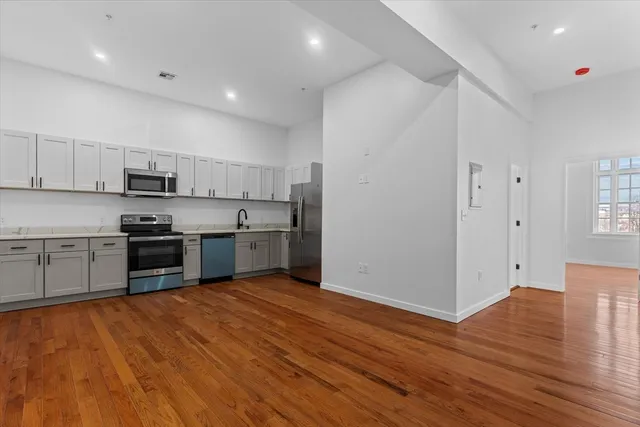 a kitchen with stainless steel appliances a stove a sink and a refrigerator