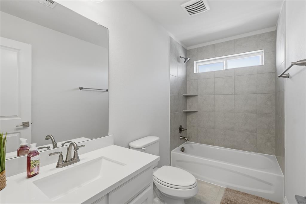 7548 Ridge Lane Grand Prairie, TX 75054 - Photo 30 of 35 Full bathroom featuring vanity and bathtub / shower combination
