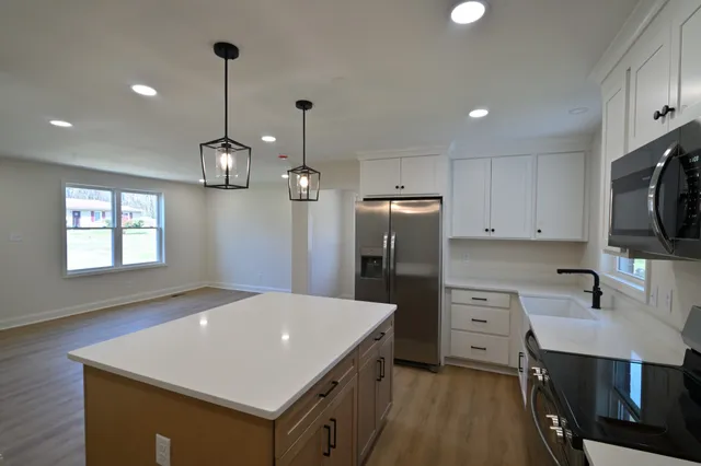 a kitchen that has a lot of cabinets and refrigerator