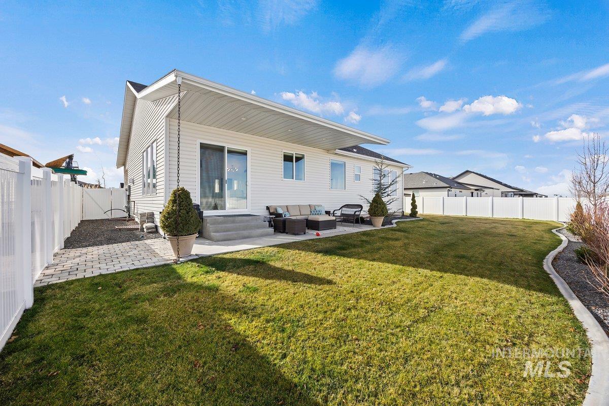 1046 Northridge Way Kimberly, ID 83341 - Photo 22 of 24 Back of property featuring an outdoor lounge area, a fenced backyard, a patio area, and a gate