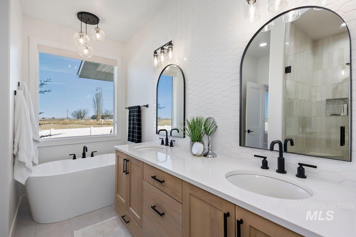1046 Northridge Way Kimberly, ID 83341 - Photo 7 of 24 Bathroom featuring double vanity, a freestanding tub, a stall shower, and light tile patterned floors