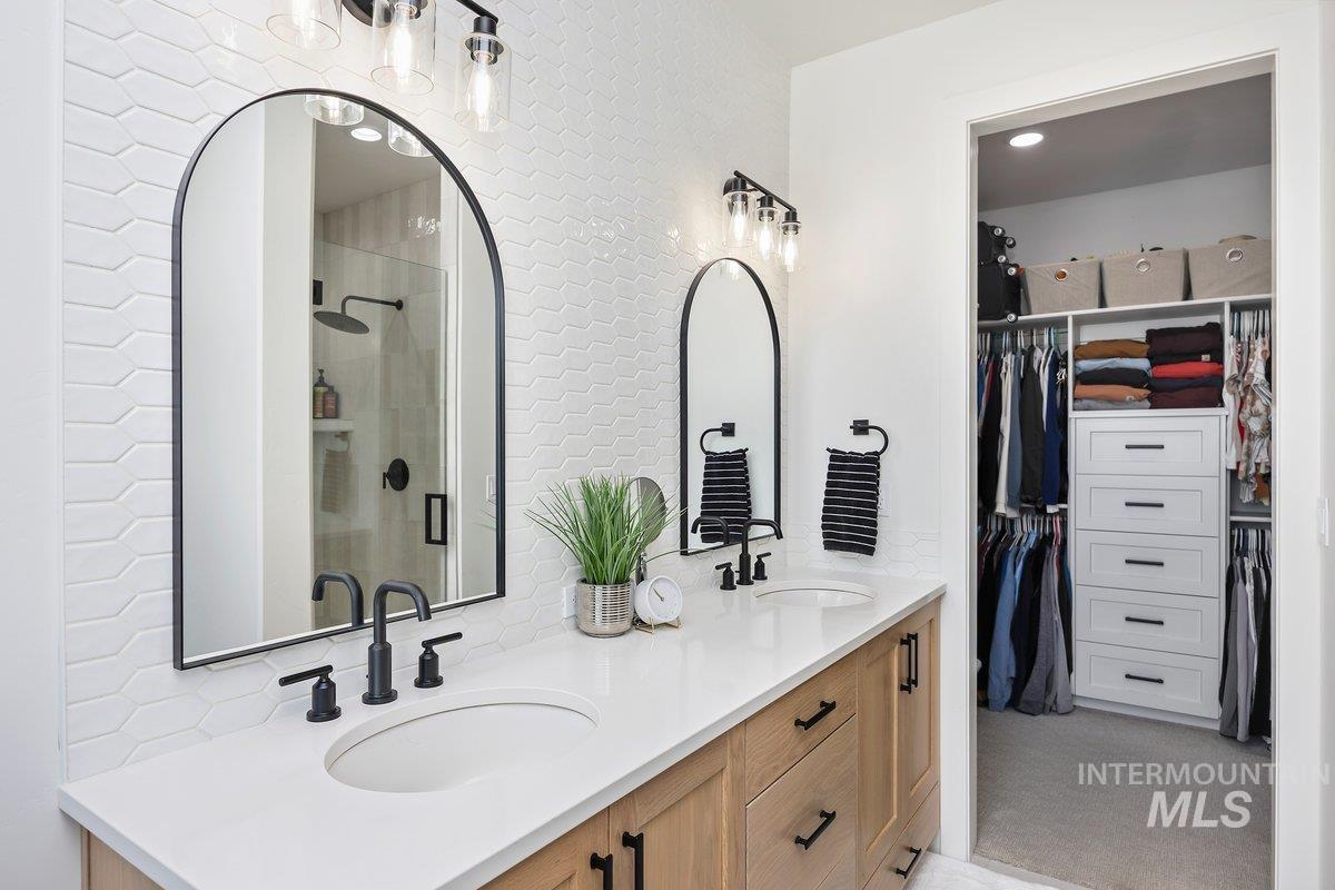 1046 Northridge Way Kimberly, ID 83341 - Photo 8 of 24 Bathroom with a walk in closet, double vanity, and a stall shower