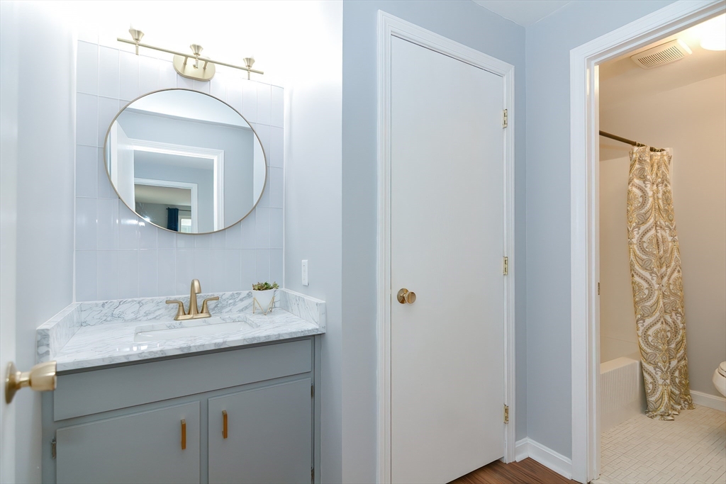 65 Mountain Gate Road, Unit 65 Ashland, MA 01721 - Photo 20 of 32 a bathroom with a sink and a mirror