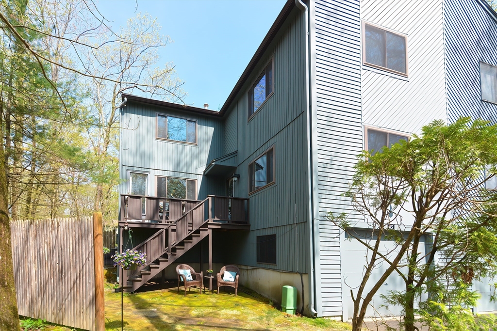 65 Mountain Gate Road, Unit 65 Ashland, MA 01721 - Photo 2 of 32 a view of a house with backyard and sitting area