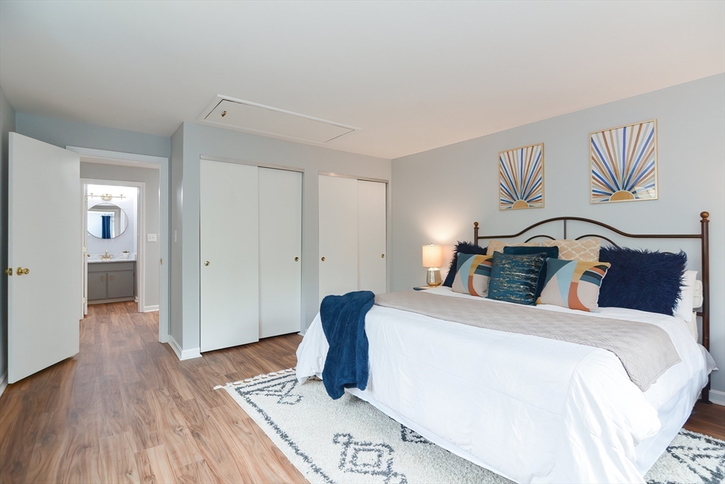 65 Mountain Gate Road, Unit 65 Ashland, MA 01721 - Photo 22 of 32 a bedroom with a bed and wooden floor