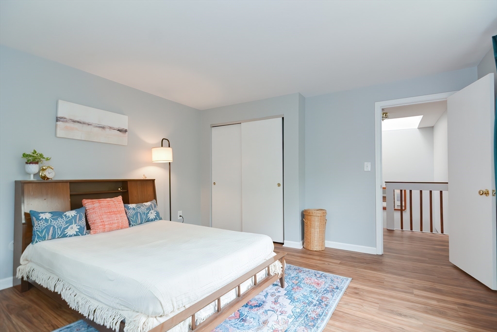 65 Mountain Gate Road, Unit 65 Ashland, MA 01721 - Photo 24 of 32 a bedroom with a bed and wooden floor