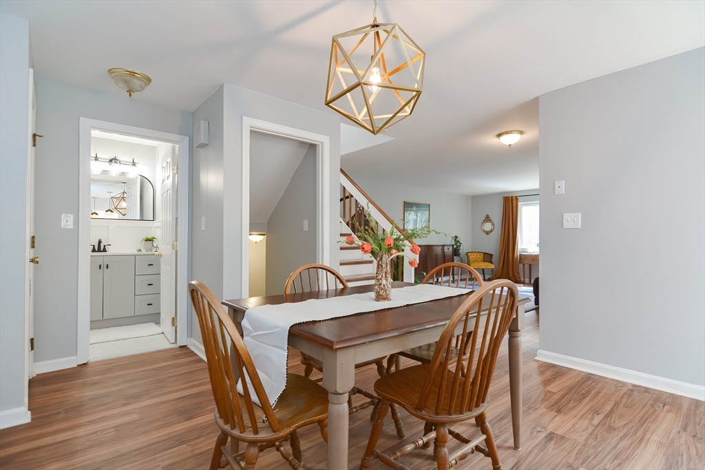 65 Mountain Gate Road, Unit 65 Ashland, MA 01721 - Photo 10 of 32 a dining room with furniture and wooden floor