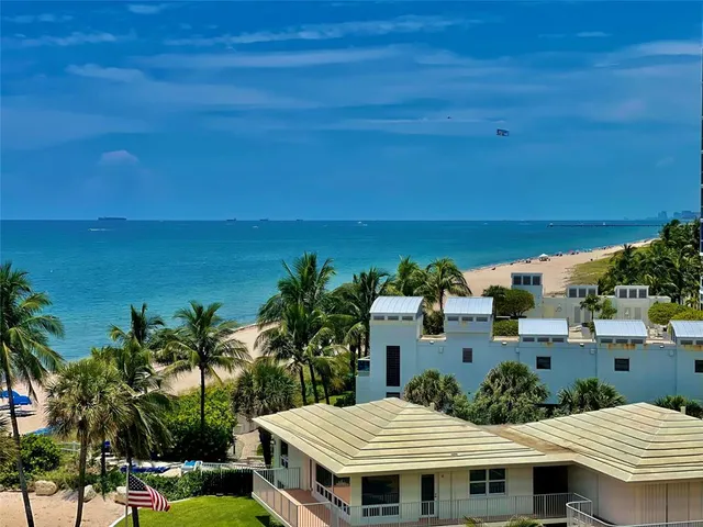 a view of a patio with table and chairs under an umbrella