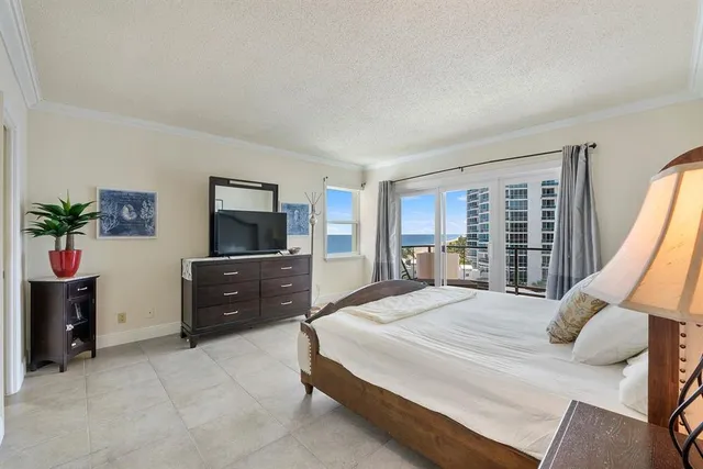 a bedroom with a bed and a television