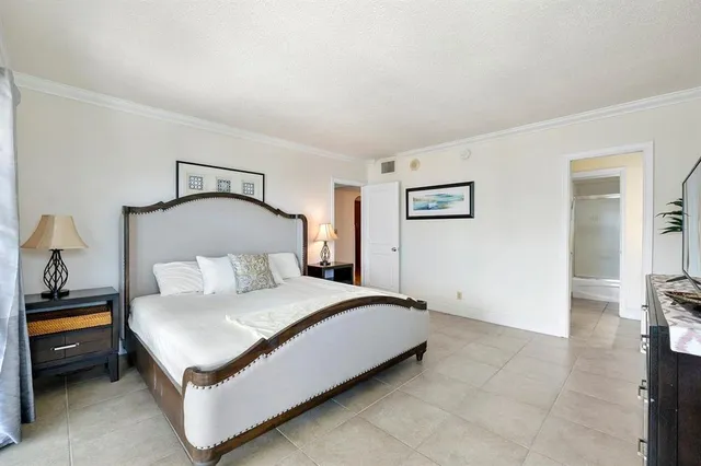 a bedroom with a bed and a view of bathroom