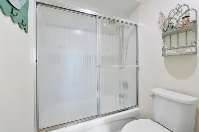 a bathroom with a shower and a toilet