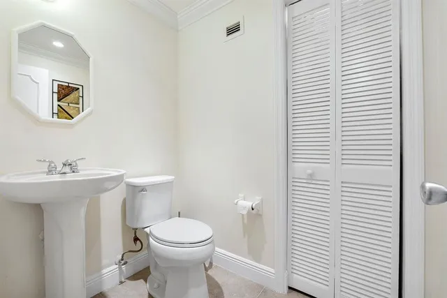 a bathroom with a toilet a sink and a mirror