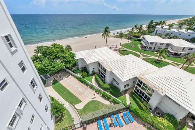 an aerial view of a house with outdoor space patio and outdoor seating