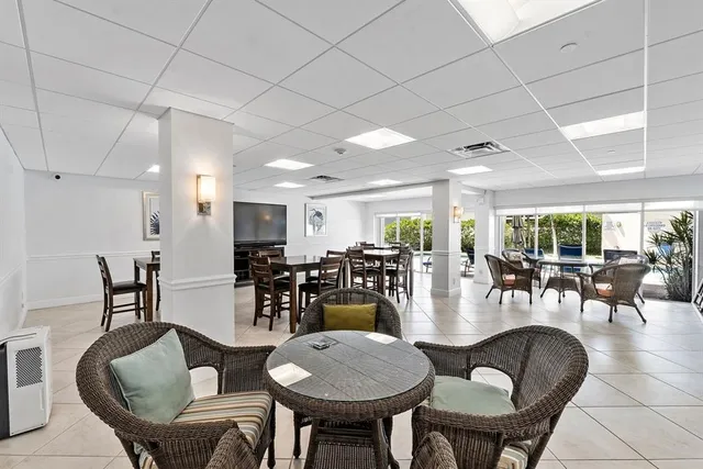 a dining room with furniture a table and kitchen view