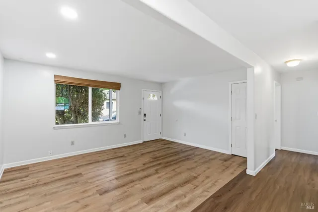wooden floor in an empty room with a window