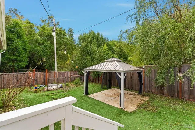a backyard of a house with table and chairs