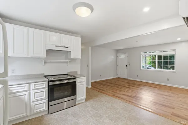 an empty room with wooden floor and closet