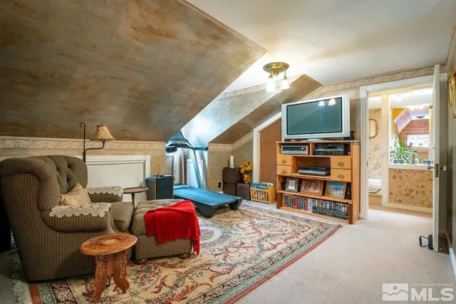 a view of a house with wooden fence and floor to ceiling windows