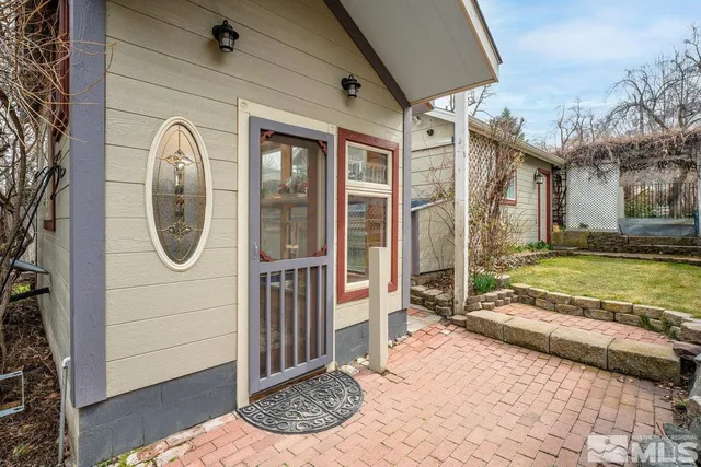 a view of backyard with deck and outdoor seating