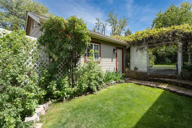 a backyard of a house with barbeque oven table and chairs