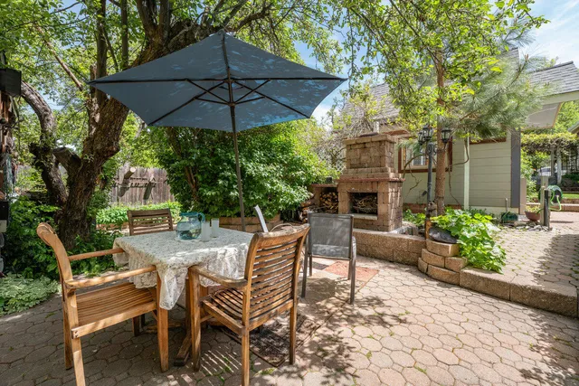 a view of a patio with table and chairs and potted plants