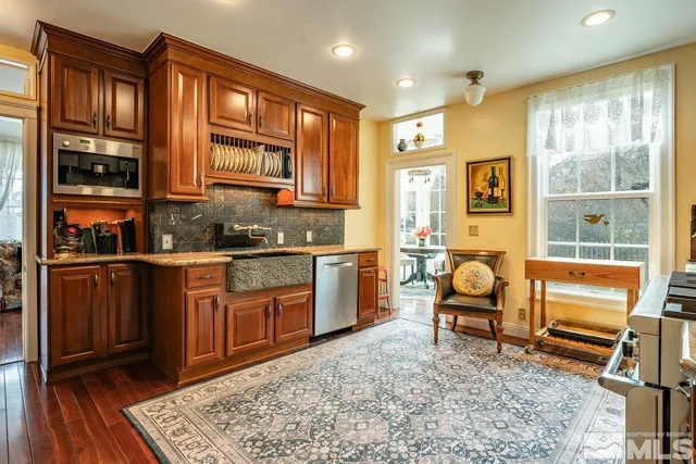 a bedroom with a bed a mirror and dresser